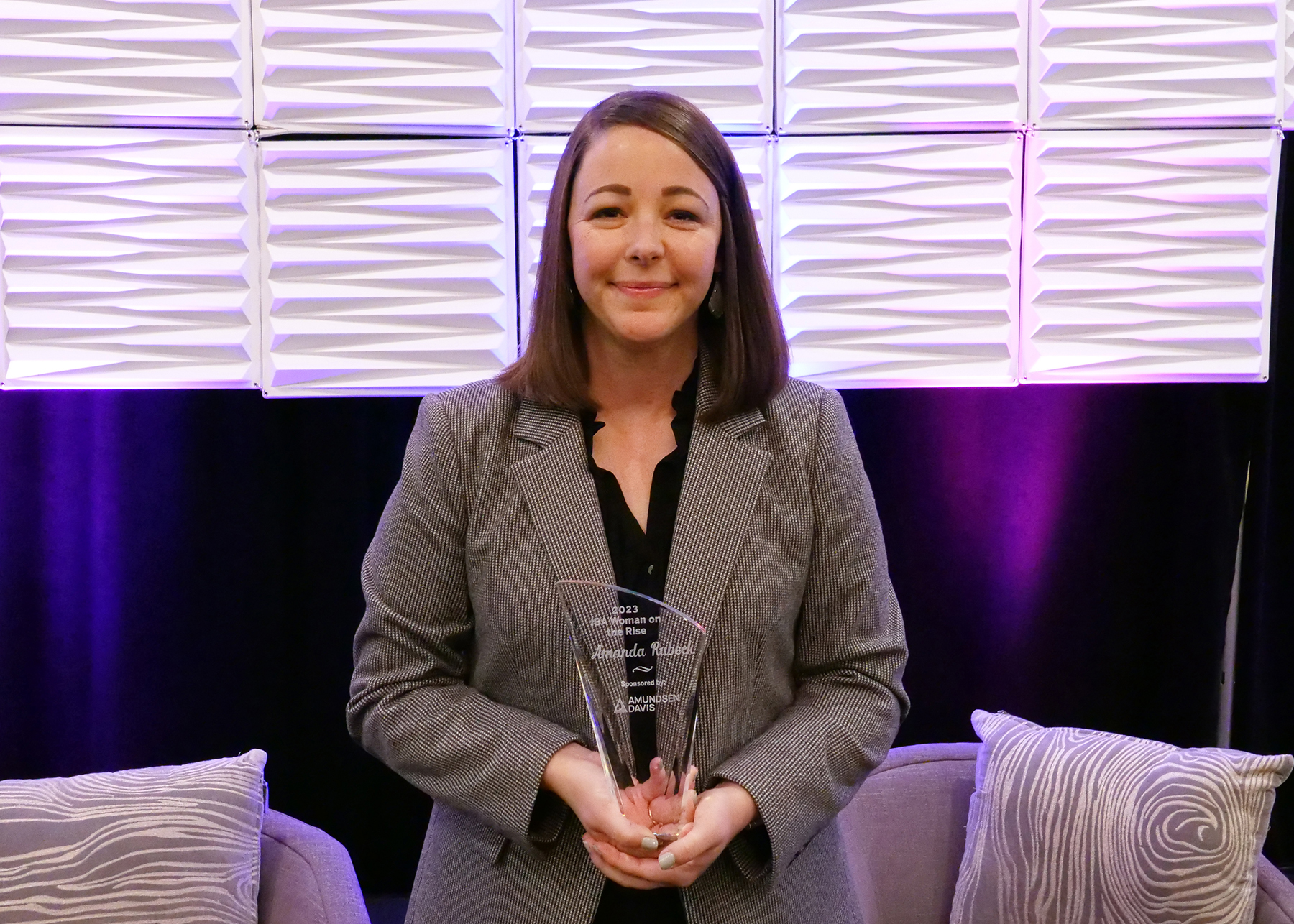 photo showing Amanda Rubeck posing with the 2023 IBA Woman on the Rise award